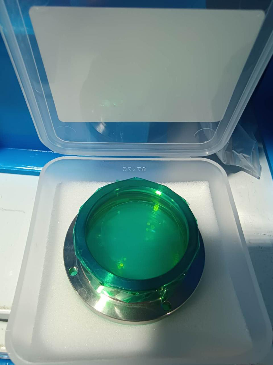 Coated focusing lens in protective case